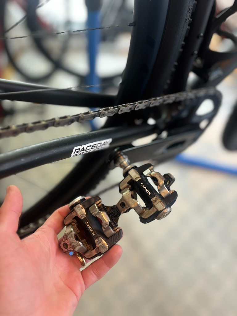 Old and replacement Garmin Rally XC100 pedal bodies during service