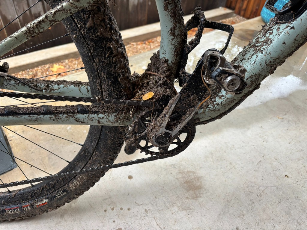 Garmin Rally XC100 pedal on a muddy bike after a wet race