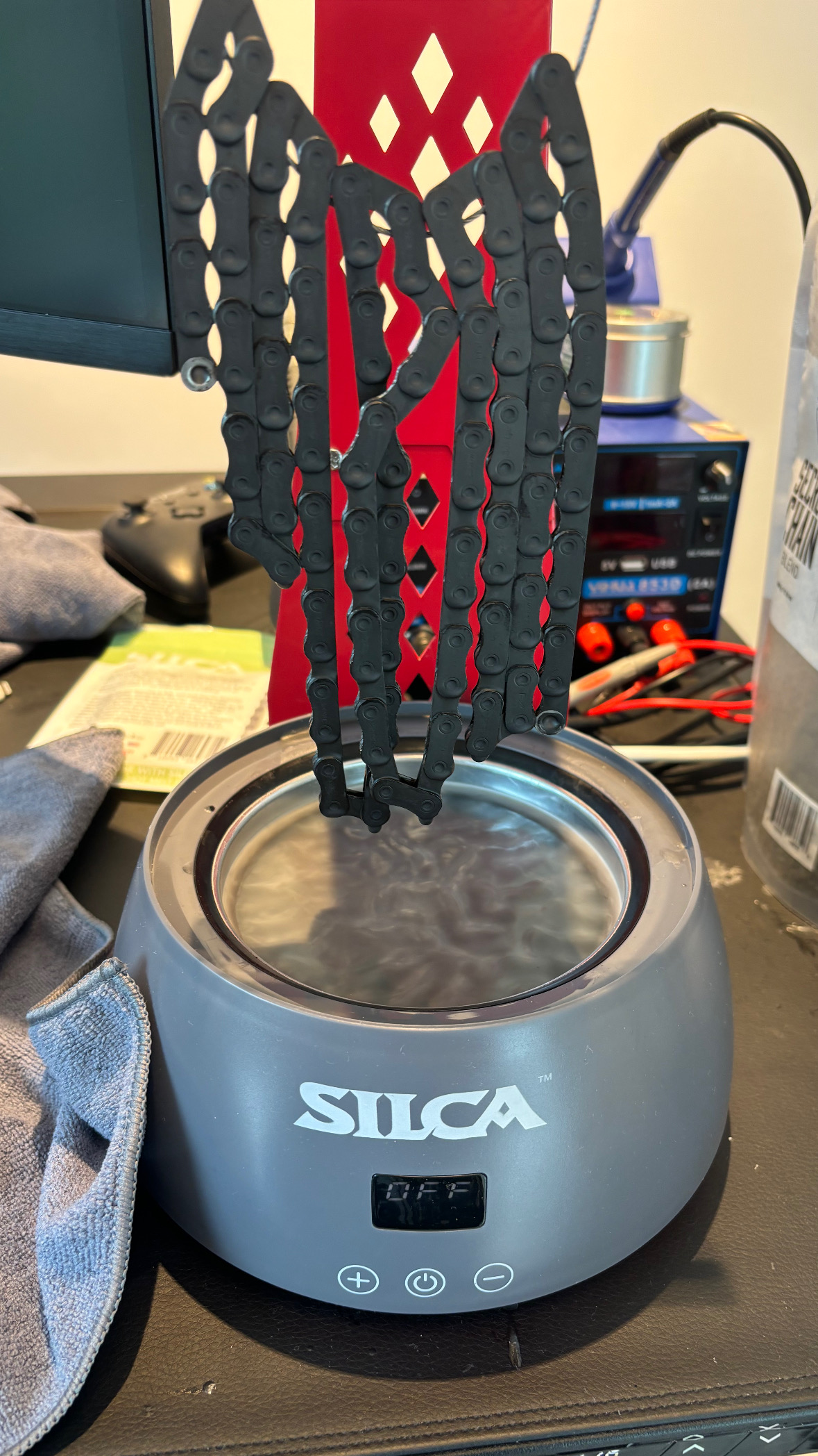 Freshly waxed chain drying above the Silca Wax Pot