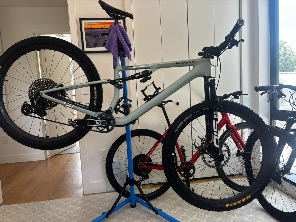 XC mountain bike in a work stand during a pre-race maintenance inspection
