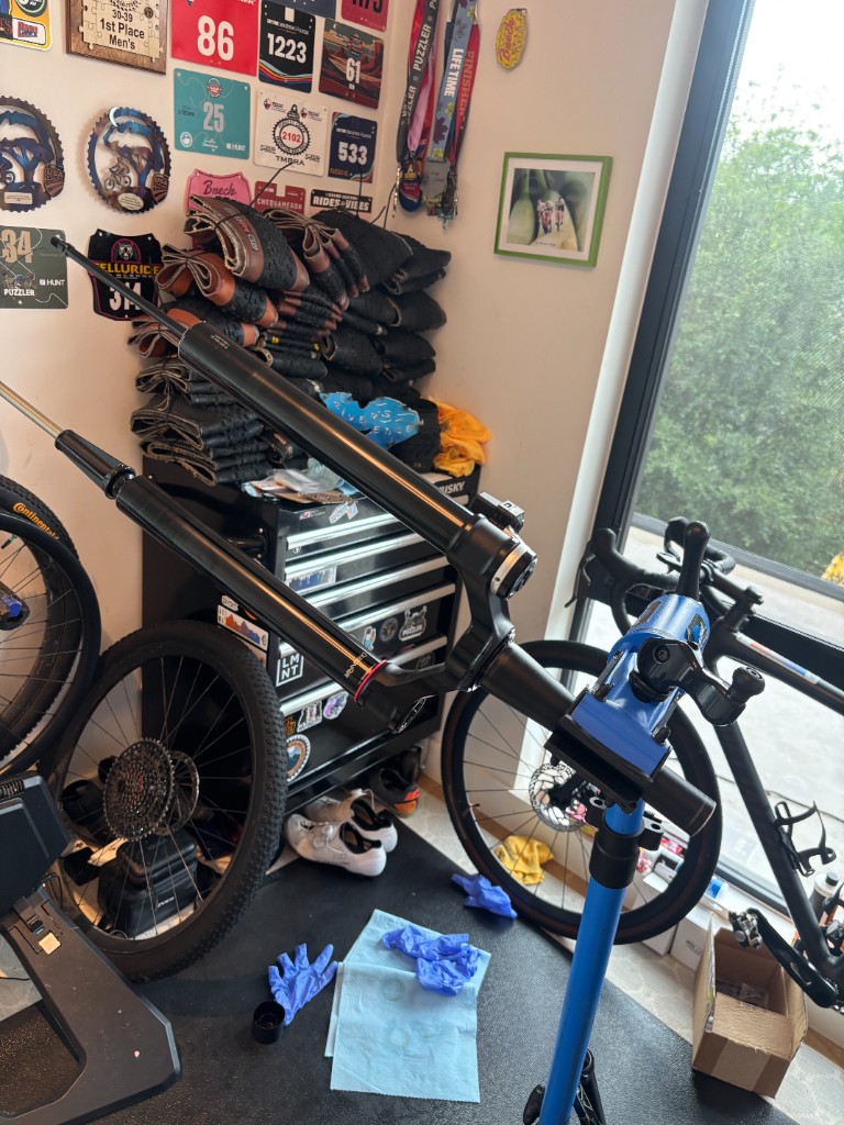 RockShox SID fork in a repair stand during lower leg service